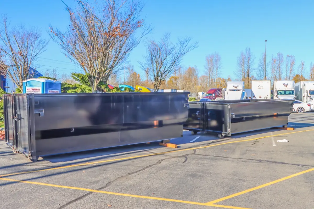 Professional dumpster rental service with roll-off container on residential driveway in Muskogee